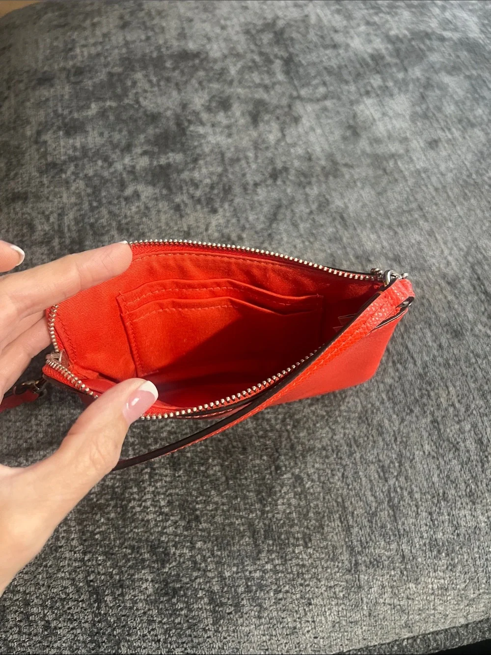 Coach orange/red Pebbled Leather wristlet.